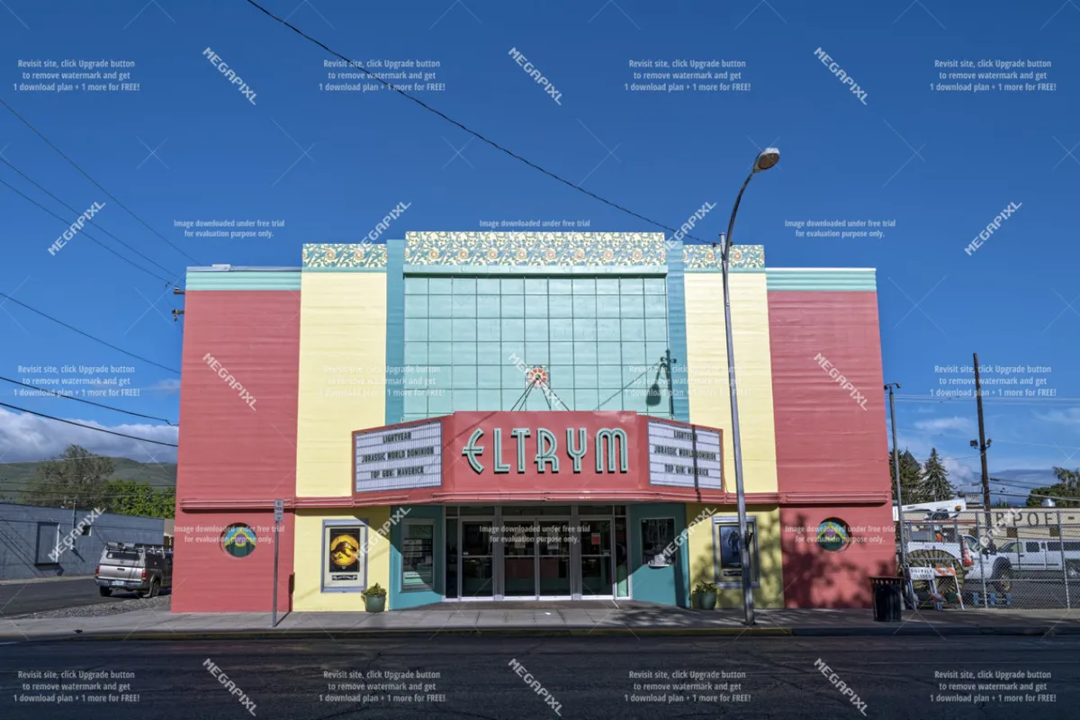A vibrant street scene centered on a historic theater with a colorful facade and dramatic marquee, reflecting the cultural offerings of the surrounding neighborhood.